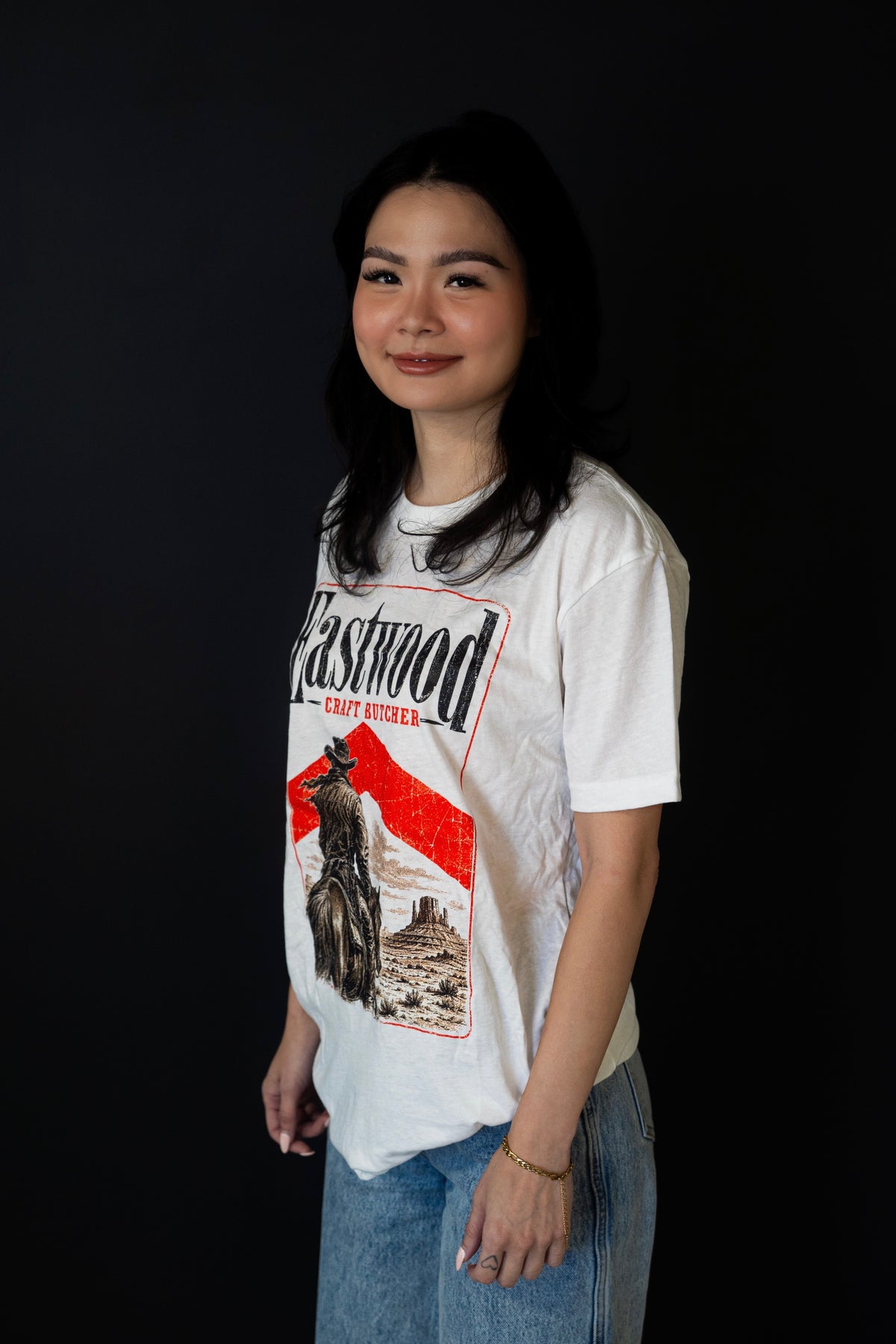 White Eastwood Craft Butcher T-shirt with cowboy on horseback and red-accented desert graphic